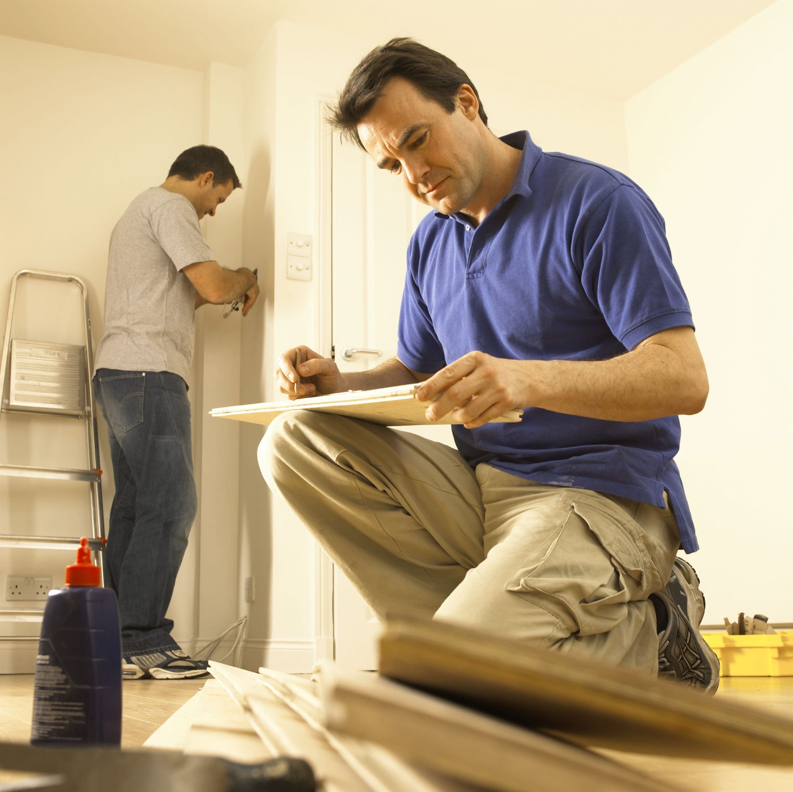 Building maintenance worker looking through plans for repairs on a room