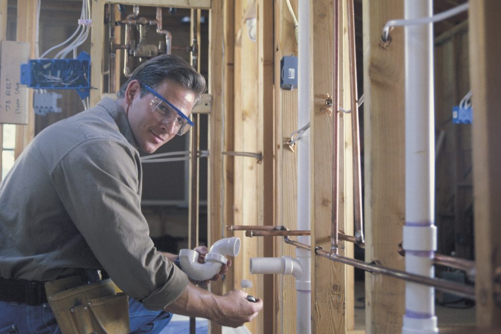 Plumber connecting PVC pipes